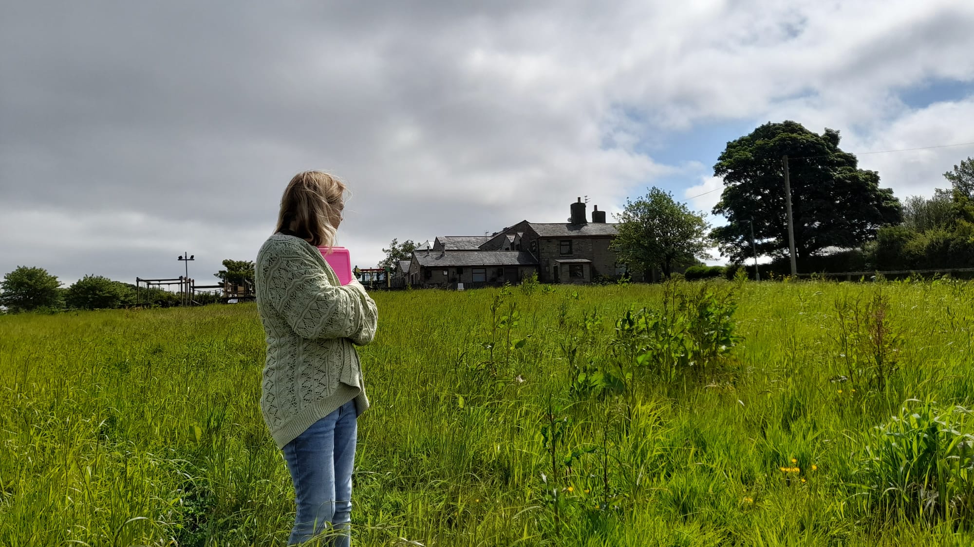 Happy genealogy client standing on her ancestral land